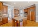 An expansive kitchen with custom wood cabinets, center island, granite counters, stainless appliances, and hardwood flooring at 4708 Wynneford Way, Raleigh, NC 27614