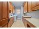 Well-equipped laundry room with plenty of counter space and wood cabinetry at 4708 Wynneford Way, Raleigh, NC 27614