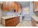Well-equipped laundry room with plenty of counter space and wood cabinetry at 4708 Wynneford Way, Raleigh, NC 27614