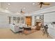 Open-concept living room with a stone fireplace, built-in storage, and plenty of natural light at 4708 Wynneford Way, Raleigh, NC 27614