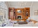 An open living room features a fireplace with built-ins, hardwood floors, vaulted ceilings, and lots of natural light at 4708 Wynneford Way, Raleigh, NC 27614