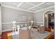 Comfortable living room with hardwood floors, coffered ceilings, and bright, neutral décor at 4708 Wynneford Way, Raleigh, NC 27614