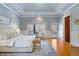 Spacious main bedroom with a tray ceiling and access to an outdoor patio at 4708 Wynneford Way, Raleigh, NC 27614