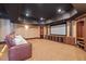Spacious media room with plush seating, custom built-ins, and a large screen for immersive entertainment at 4708 Wynneford Way, Raleigh, NC 27614