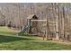 playset with slide and swingset in natural wooded setting on lush green lawn at 4708 Wynneford Way, Raleigh, NC 27614