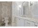 Elegant powder room with stylish wallpaper, marble countertops, and modern fixtures at 4708 Wynneford Way, Raleigh, NC 27614