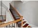 Wooden staircase with a decorative black iron railing and white walls at 4708 Wynneford Way, Raleigh, NC 27614
