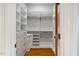 Walk-in closet with custom shelves and drawers to maximize organization at 4708 Wynneford Way, Raleigh, NC 27614