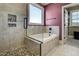 This bathroom features a tub with a shower and pebble floor at 50 Setter Ct, Angier, NC 27501