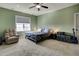 Bedroom with green walls, cozy chair, carpet, and window with blinds for natural light at 50 Setter Ct, Angier, NC 27501