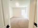 Spacious, carpeted bedroom with a large window providing natural light, and fresh neutral wall color at 5161 Church Rd # 17, New Hill, NC 27562