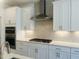 Modern kitchen featuring white cabinetry, stainless steel appliances, and a gray backsplash at 5161 Church Rd # 17, New Hill, NC 27562