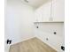 Laundry room with cabinets for storage and vinyl wood flooring at 5161 Church Rd # 17, New Hill, NC 27562