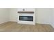 Bright living room featuring a shiplap fireplace with a rustic wood mantel and light wood flooring at 5161 Church Rd # 17, New Hill, NC 27562