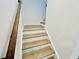 Wooden staircase with white risers and a wooden handrail at 5161 Church Rd # 17, New Hill, NC 27562