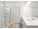 Bathroom featuring double sinks, a walk-in shower, and neutral flooring at 60 Commons Cir, Clayton, NC 27520