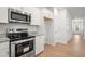 Modern kitchen featuring stainless steel appliances and white cabinets at 60 Commons Cir, Clayton, NC 27520