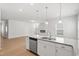 Open concept kitchen features stainless appliances, granite counters, and a view of the living space at 60 Commons Cir, Clayton, NC 27520