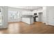 Bright kitchen features white cabinets, stainless steel appliances, and a breakfast bar with granite countertops at 60 Commons Cir, Clayton, NC 27520