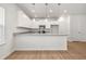 Beautiful kitchen features stainless steel appliances, white cabinets and granite countertops and breakfast bar at 60 Commons Cir, Clayton, NC 27520