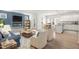 Bright open-concept living room with fireplace, stylish furniture, and dining area at 60 Commons Cir, Clayton, NC 27520
