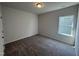 Neutral bedroom with a carpeted floor, a ceiling light, and a bright window at 60 Commons Cir, Clayton, NC 27520