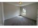 Neutral bedroom with a carpeted floor, a ceiling light, and a bright window at 60 Commons Cir, Clayton, NC 27520