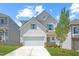 Charming two-story home with an attached garage and a well-maintained yard at 60 Commons Cir, Clayton, NC 27520