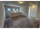 Cozy loft area with neutral carpet and natural light from small square windows at 60 Commons Cir, Clayton, NC 27520
