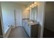Main bathroom featuring a double sink vanity with granite countertops, tile flooring, and a bathtub at 60 Commons Cir, Clayton, NC 27520