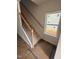 Bright stairway with wood handrail and metal balusters next to a window at 60 Commons Cir, Clayton, NC 27520
