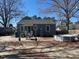 Back of home showing small patio and backyard area with shade trees, pool, and sitting area at 606 N Orange Ave, Dunn, NC 28334