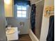 Cozy bathroom featuring a shower/tub combo, vanity, and a window at 606 N Orange Ave, Dunn, NC 28334