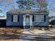 Charming single story home with blue siding, landscaped front yard, and inviting front porch at 606 N Orange Ave, Dunn, NC 28334