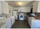 Bright kitchen featuring appliances, sleek countertops, and ample storage space at 606 N Orange Ave, Dunn, NC 28334
