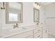 Bathroom featuring double sinks, quartz countertops, and decorative mirrors at 618 Tart Town Rd, Dunn, NC 28334