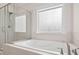 Bathroom featuring a separate shower, soaking tub, and decorative window at 618 Tart Town Rd, Dunn, NC 28334