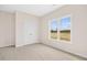 Bright bedroom featuring neutral carpet, a window and closet space at 618 Tart Town Rd, Dunn, NC 28334