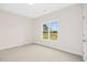 Bedroom featuring neutral carpet and a large window providing ample natural light at 618 Tart Town Rd, Dunn, NC 28334