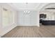 Open-concept dining area with modern flooring and stylish chandelier at 618 Tart Town Rd, Dunn, NC 28334