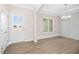 Bright entryway featuring modern flooring, fresh paint, and a stylish chandelier at 618 Tart Town Rd, Dunn, NC 28334