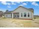 Rear exterior of home featuring gray siding, dark roof, and a covered porch at 618 Tart Town Rd, Dunn, NC 28334