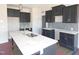 This kitchen features a large island, gray cabinets and stainless steel sink at 618 Tart Town Rd, Dunn, NC 28334