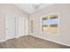 Bright room with large windows, glass paneled door, and light wood floors at 618 Tart Town Rd, Dunn, NC 28334
