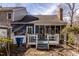 Backyard featuring a deck, enclosed sunroom, and lush landscaping at 748 Weathergreen Dr, Raleigh, NC 27615