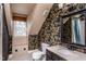 Stylish bathroom featuring patterned wallpaper, vanity, mirror, and tile flooring at 748 Weathergreen Dr, Raleigh, NC 27615