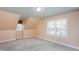 A bright bedroom featuring plush carpeting and a charming window seat for cozy relaxation at 748 Weathergreen Dr, Raleigh, NC 27615