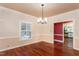Light-filled dining room with hardwood floors and a view of the connecting rooms at 748 Weathergreen Dr, Raleigh, NC 27615