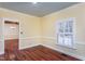 Bright dining room featuring hardwood floors, crown molding, and natural light from shuttered window at 748 Weathergreen Dr, Raleigh, NC 27615