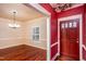 Elegant entryway featuring beautiful hardwood floors and decorative wallpaper at 748 Weathergreen Dr, Raleigh, NC 27615